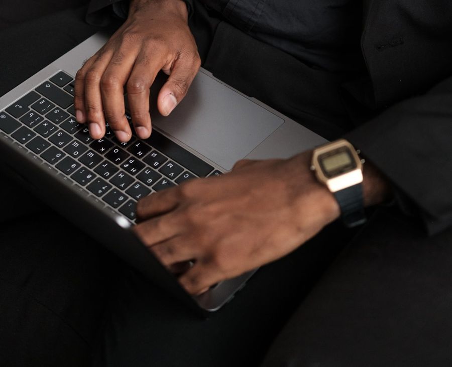 Hands working on a laptop building analytics and reports